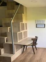 a room with a staircase with a chair and a table at Guesthouse Family Bosnic in Plitvička Jezera