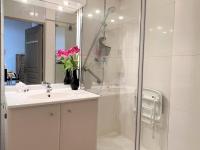a bathroom with a sink and a shower with a glass door at Appartement Cambo-les-Bains, 2 pièces, 2 personnes - FR-1-495-57 in Cambo-les-Bains
