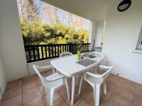 a white table and chairs on a balcony with a window at Appartement Cambo-les-Bains, 2 pièces, 2 personnes - FR-1-495-57 in Cambo-les-Bains