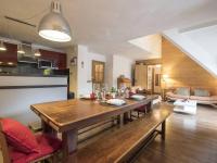 a kitchen and living room with a wooden dining room table at Appartement Saint-Lary-Soulan, 4 pièces, 10 personnes - FR-1-296-340 in Saint-Lary-Soulan