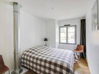 1 dormitorio con cama a cuadros y ventana en Maison Cauterets, 4 pièces, 7 personnes - FR-1-401-173, en Cauterets