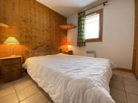 a bedroom with a large bed and a window at Appartement Praz-sur-Arly, 3 pièces, 6 personnes - FR-1-603-16 in Praz-sur-Arly