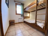 a bedroom with two bunk beds and a tiled floor at Appartement Praz-sur-Arly, 3 pièces, 6 personnes - FR-1-603-16 in Praz-sur-Arly