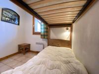 a bedroom with a bed in the corner of a room at Appartement Praz-sur-Arly, 3 pièces, 6 personnes - FR-1-603-16 in Praz-sur-Arly