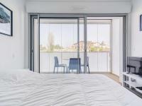 a bedroom with a bed and a table and chairs at Appartement Saint-Jean-de-Luz, 2 pièces, 4 personnes - FR-1-4-586 in Saint-Jean-de-Luz