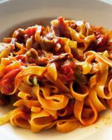 a plate of pasta with meat and sauce at Fattoria Raffaelli in Colle Farnese