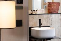 a bathroom with a white sink and a lamp at Hôtel Toujours &amp; Spa in Paris