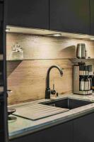 a kitchen counter with a sink and a coffee maker at Dachstein West Apartment T4 in Russbach am Pass Gschütt