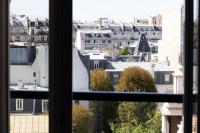 a view of a city from a window at Hôtel Toujours &amp; Spa in Paris