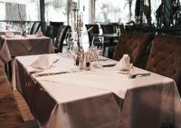 a table with wine glasses and napkins on it at Hotel-Restaurant Das Grambacher I FREE PARKING I SELF CHECK-IN in Graz