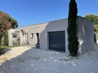 a white building with a garage with a tree at Villa Alberes Sorede 7 km of beaches in Sorède