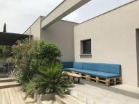 a blue couch sitting on the side of a building at Villa Alberes Sorede 7 km of beaches in Sorède
