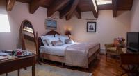 a bedroom with a bed and a desk and a television at The Pucic Palace in Dubrovnik
