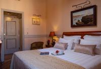 a bedroom with a bed with a plate of food on it at The Pucic Palace in Dubrovnik