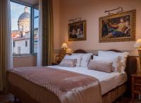 a bedroom with a large bed and a window at The Pucic Palace in Dubrovnik