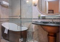 a bathroom with a tub and a sink and a mirror at The Pucic Palace in Dubrovnik