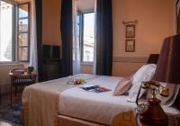 a hotel room with a bed with a table and a window at The Pucic Palace in Dubrovnik