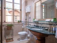 a bathroom with a sink and a toilet and a mirror at The Pucic Palace in Dubrovnik