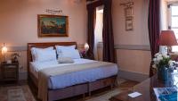a bedroom with a bed and a painting on the wall at The Pucic Palace in Dubrovnik