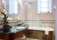 a bathroom with a tub and a sink and a mirror at The Pucic Palace in Dubrovnik