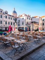 a group of tables and chairs in a courtyard at The Pucic Palace in Dubrovnik