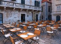 a group of tables and chairs in front of a building at The Pucic Palace in Dubrovnik