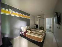 Postel nebo postele na pokoji v ubytování Aen Guy Boutique Hotel
