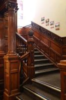 a staircase in a building with wood paneling at Astor Hyde Park Hostel in London