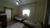 a bedroom with two beds and a window at Residência Manto Azul in Aparecida