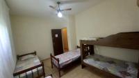 a room with two bunk beds and a ceiling fan at Residência Manto Azul in Aparecida