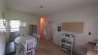 a kitchen with a table and chairs in a room at Residência Manto Azul in Aparecida
