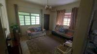 a living room with two couches and two windows at Residência Manto Azul in Aparecida