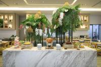 a table with plants on it in a restaurant at Panan Krabi Resort in Ao Nang Beach
