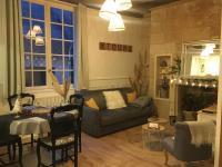 a living room with a couch and a table at Vieux Tours, Charmant T2 40m2, 4 pers, lumineux in Tours