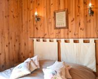 a bed in a room with a wooden wall at Pavillon de 4 couchages, très calme, proche centre ville in Albi