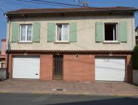 a house with two garage doors on a street at Pavillon de 4 couchages, très calme, proche centre ville in Albi