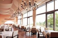 a dining room with tables and chairs and large windows at L'Hotel de Hiei in Kyoto