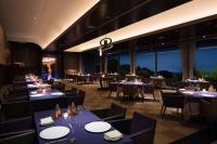 a restaurant with blue tables and chairs and windows at L'Hotel de Hiei in Kyoto
