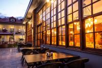 a restaurant with tables and chairs and large windows at Zanike hotel in Trabzon