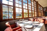 a restaurant with tables and chairs and large windows at Zanike hotel in Trabzon