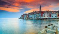a group of buildings on the shore of the water at The Melegran in Rovinj