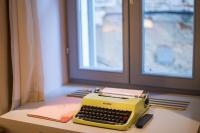 a yellow typewriter sitting on a table next to a window at The Melegran in Rovinj