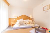 A bed or beds in a room at Albergo Canazei