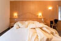 A bed or beds in a room at Albergo Canazei