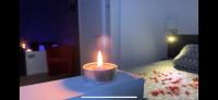 a candle sitting on a table in a living room at Suite pour les Amoureux_Val d&#39;Europe Disney in Coupvray