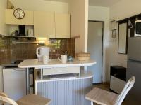 a small kitchen with a counter and a clock on the wall at Appartement Sainte-Maxime, 2 pièces, 4 personnes - FR-1-226-500 in Sainte-Maxime