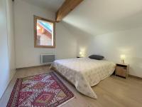 a bedroom with a bed and a window and a rug at Chalet Puy-Saint-Pierre, 4 pièces, 8 personnes - FR-1-330C-136 in Puy-Saint-Pierre