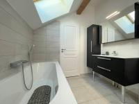 a bathroom with a bath tub and a sink at Chalet Puy-Saint-Pierre, 4 pièces, 8 personnes - FR-1-330C-136 in Puy-Saint-Pierre