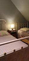 a bedroom with two beds and a table with a lamp at Horizon Aubrac Laguiole in Laguiole