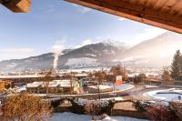 a view of a town with snow covered mountains at Alpine View Apartments in Niedernsill